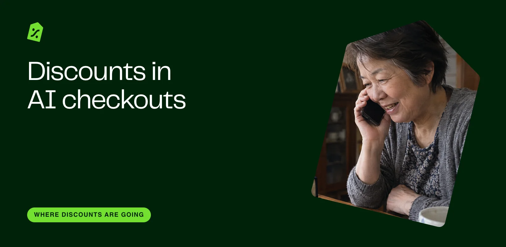 An older woman at home smiles as she talks on her phone.